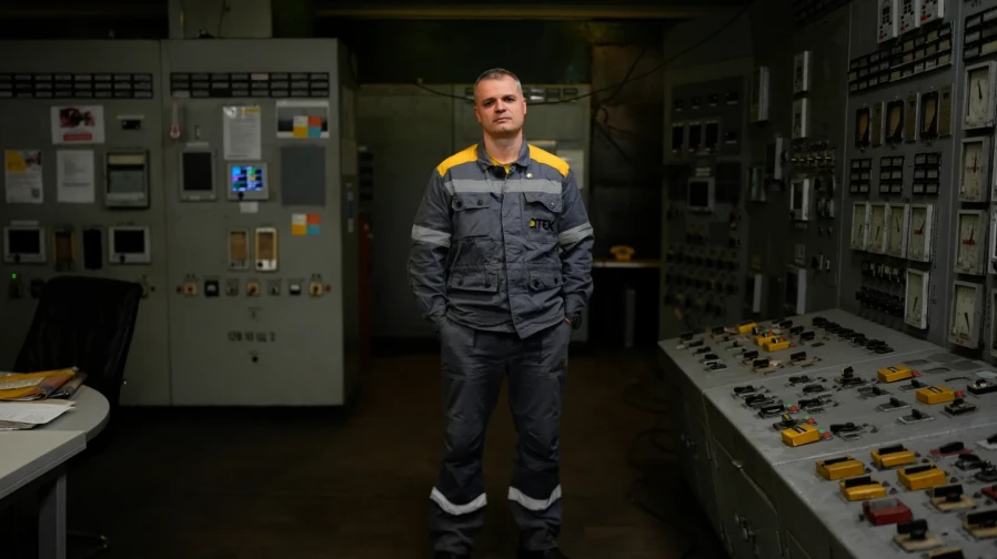 Mykhailo, 45, a senior power unit engineer, who declined to give his surname due to security concerns, poses for a portrait in the control room of a Ukrainian thermal power plant, Wednesday, Oct. 29, 2025. “If all the turbine operators hid during attacks,